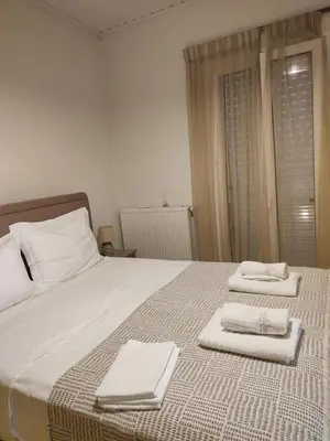 a bedroom with a bed with towels on it at The Gem Of Talos Apartment in Stalos