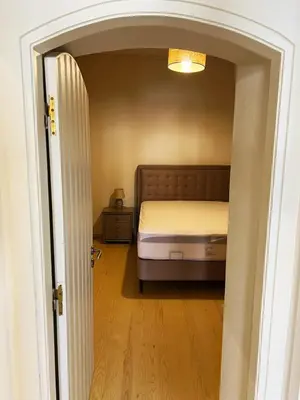 a bedroom with a bed and an open door at The Gem Of Talos Apartment in Stalos