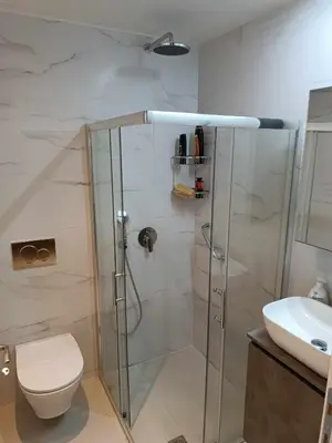 a bathroom with a shower and a toilet and a sink at The Gem Of Talos Apartment in Stalos