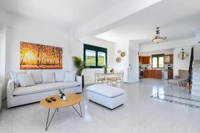 a living room with a couch and a table at Villa Giannari in Stalos
