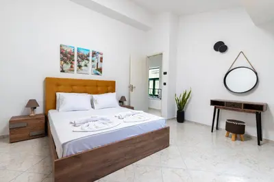 a bedroom with a bed with a mirror and a table at Villa Giannari in Stalos