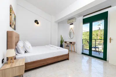 a bedroom with a bed and a sliding glass door at Villa Giannari in Stalos