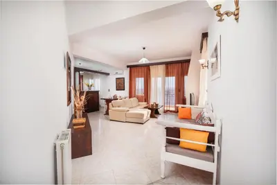 a living room with a couch and a table at Aptera Dream Apartment in Áptera