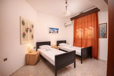 a bedroom with two beds and a window at Aptera Dream Apartment in Áptera