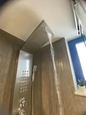 a shower with water coming out of the ceiling at Rouan Studios in Souda