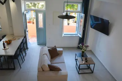 a living room with a couch and a table at Para thin alós House in Chania Town