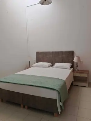 a bedroom with a large bed with a green blanket at Para thin alós House in Chania Town