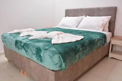 a bed with two towels on top of it at Para thin alós House in Chania Town