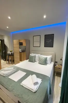 a bedroom with a large bed with towels on it at Rouan studios 1 in Souda