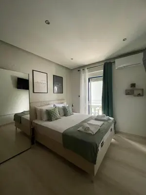 a bedroom with a large bed and a window at Rouan studios 1 in Souda