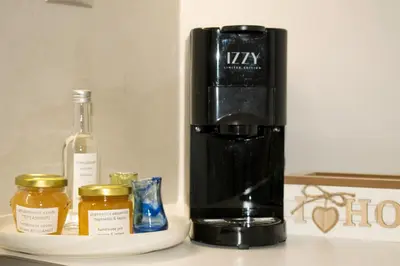 a black coffee maker next to a bottle of wine at ELflat - chania city living in Chania Town