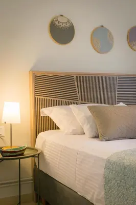 a bedroom with a bed and a table and plates on the wall at ELflat - chania city living in Chania Town