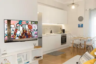 a kitchen and a living room with a tv on a wall at ELflat - chania city living in Chania Town