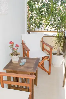 a room with a table and chairs and plants at ELflat - chania city living in Chania Town
