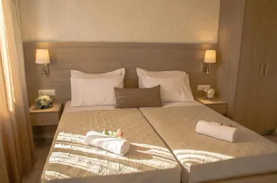 a bedroom with a large bed with two towels on it at Studios George in Palaiochóra