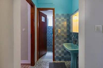 a bathroom with a sink and a toilet and a mirror at Kaliopi's Apartments in Chania Town