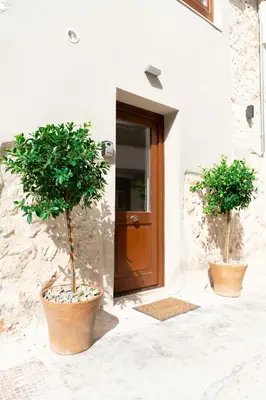 two potted trees sitting in front of a door at Casa Di Sabbia in Chania Town