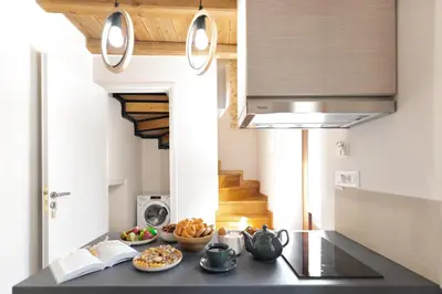 a kitchen with a table with food on it at Casa Di Sabbia in Chania Town