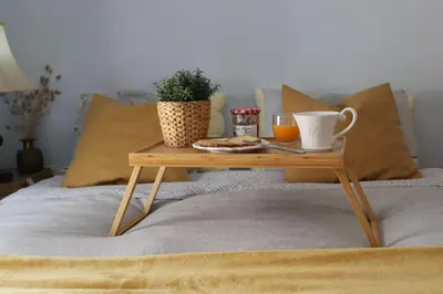 a coffee table on a bed with a cup of coffee at Upper Side Koum-Kapi in Chania Town