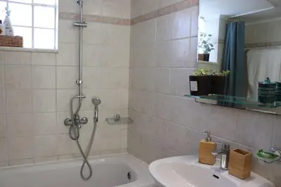 a bathroom with a shower and a sink and a tub at Upper Side Koum-Kapi in Chania Town