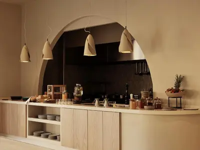 a kitchen with an archway over a counter with dishes at Tella Thera, a Member of Design Hotels in Kissamos