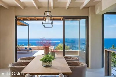 a dining room with a table and chairs at Elafonisi Villas in Livadia