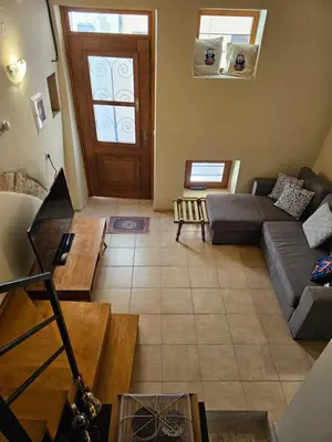 a living room with a couch and a door at Casa Stella in Chania Town