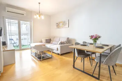 a living room with a table and a couch at Cozy Apartment 50m to beach, 5min walk to Old Town in Chania Town