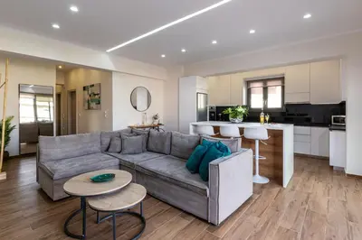 a living room with a couch and a kitchen at Galanidis Luxury Apartments in Perivólia