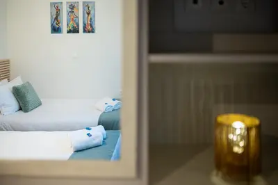 a hotel room with a bed with towels on it at Galanidis Luxury Apartments in Perivólia