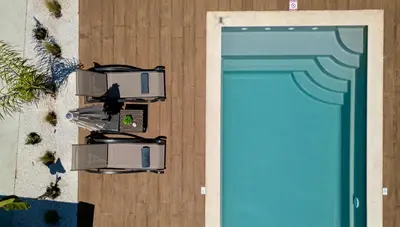 an overhead view of two chairs next to a pool at Galanidis Luxury Apartments in Perivólia