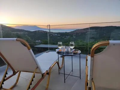 a balcony with a table and two glasses of wine at Christos in Kissamos