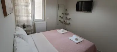 a bedroom with a bed with two white towels on it at Christos in Kissamos
