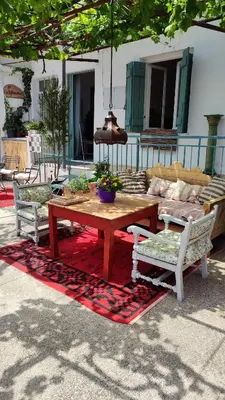 a wooden table with two chairs and a couch at Η αυλή της Ασπασίας, Χανιά Κρήτη in Lákkoi