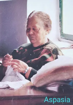 a woman sitting at a desk working on a shoe at Η αυλή της Ασπασίας, Χανιά Κρήτη in Lákkoi