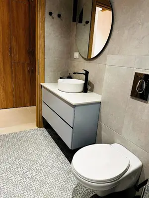 a bathroom with a toilet and a sink and a mirror at Roussos Place - Next To Splantzia Square - 2bd 2ba in Chania Town