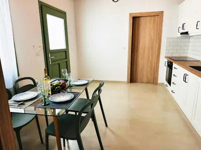 a kitchen and dining room with a table and chairs at Roussos Place - Next To Splantzia Square - 2bd 2ba in Chania Town