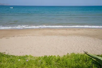 a sandy beach with the ocean in the background at The Seaside Villa in Chania Town