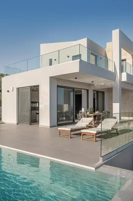 a house with a swimming pool next to a house at Villa Levante With Sea View in Plataniás