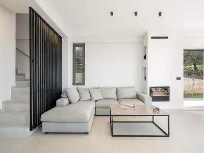 a living room with a couch and a table at Villa Zefyros With Sea View in Plataniás