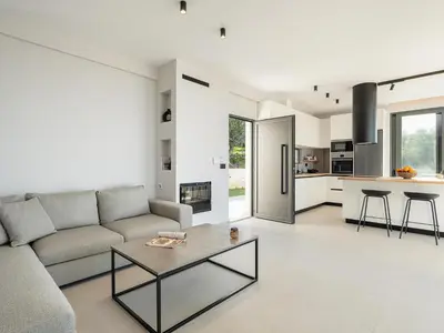 a living room with a couch and a table at Villa Zefyros With Sea View in Plataniás