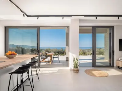 a kitchen with a view of the ocean from a house at Villa Zefyros With Sea View in Plataniás