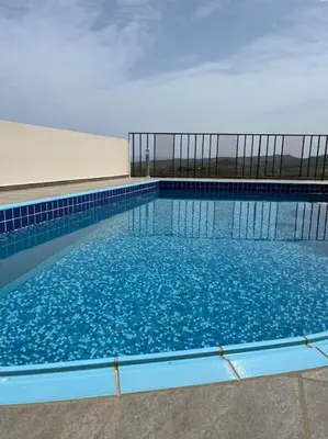 a large pool of blue water in a building at Ion villa - Xirokampi in Ayiá