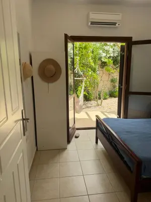 a bedroom with a bed and a door to a patio at Villa Europa Ravdoucha Private Pool and Amazing View in Ravdhoúkha
