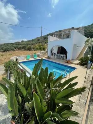 a villa with a swimming pool and a house at Villa Europa Ravdoucha Private Pool and Amazing View in Ravdhoúkha