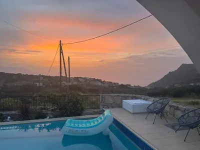 a swimming pool with a view of a sunset at Villa Europa Ravdoucha Private Pool and Amazing View in Ravdhoúkha