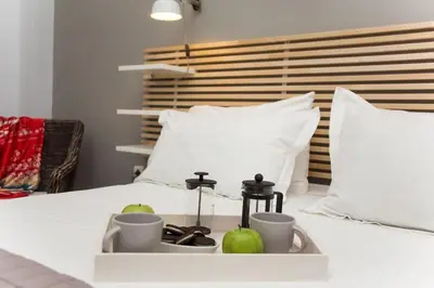 a tray with apples and cups on a bed at Modern House in the Old Town in Chania Town