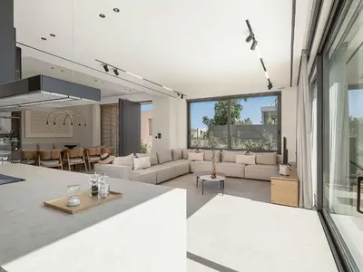 a living room with white furniture and a kitchen at Sancy Luxury Villa I 400m beach, 