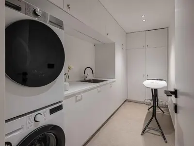 a white kitchen with a washer and a sink at Sancy Luxury Villa I 400m beach, 