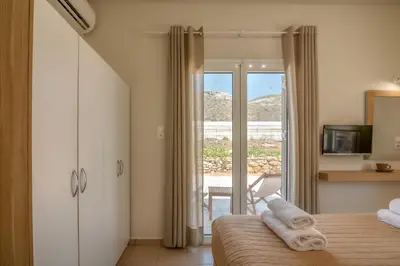 a hotel room with a bed with towels on it at Koutris Apartment 1 in Falasarna